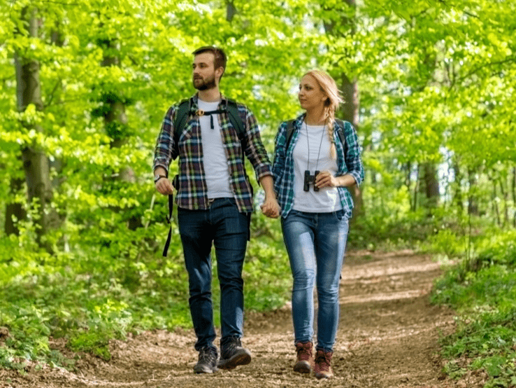 Man and woman walking in the forest